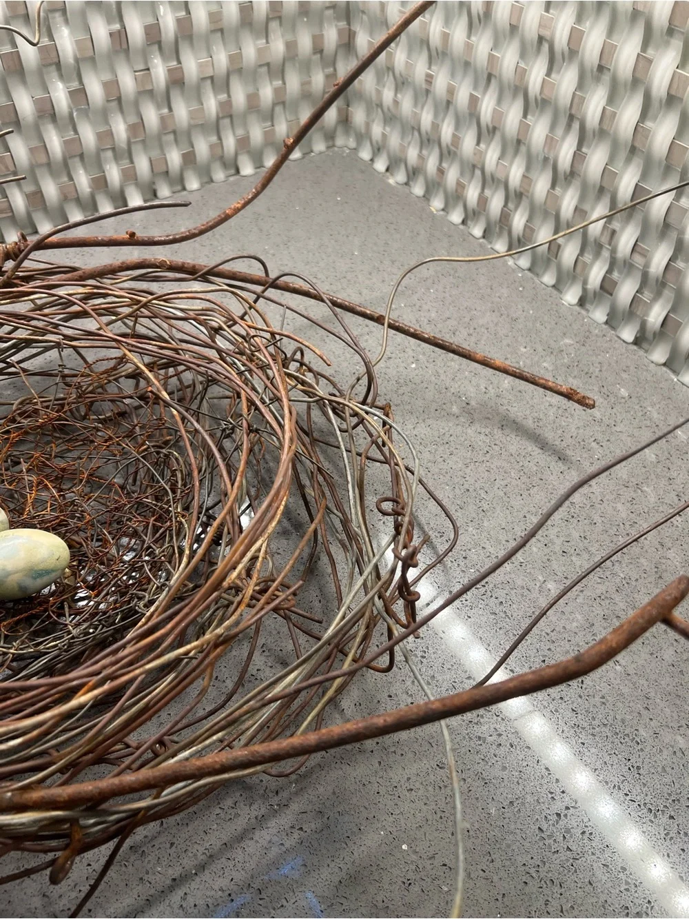 Metal rustic twig nest containing three artificial eggs decorative art